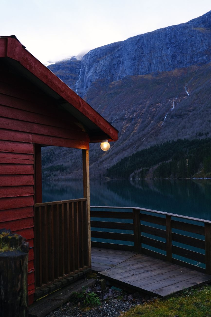 Panoramic view of Norwegian fjord and wooden cabin