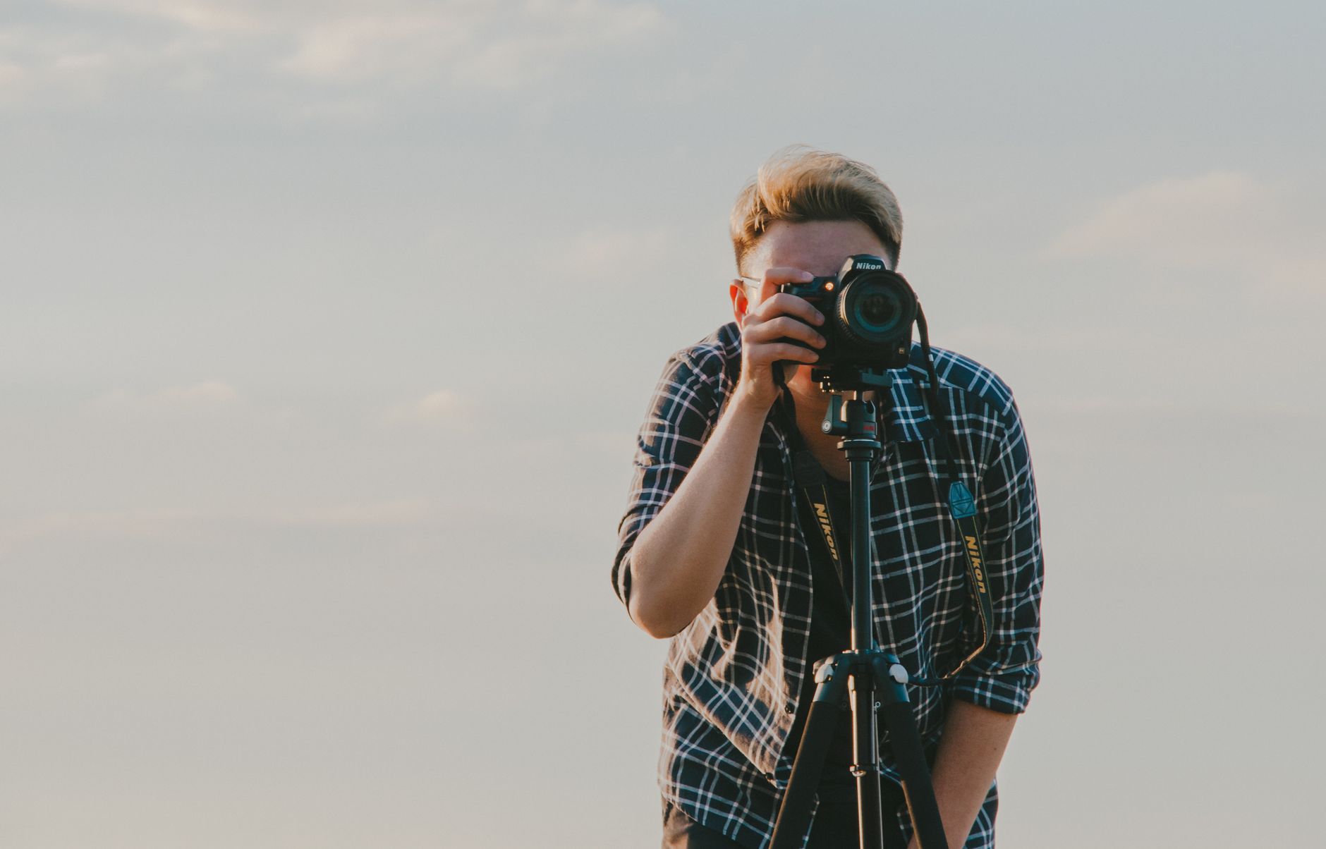 Professional photographer capturing scenic sunset landscape